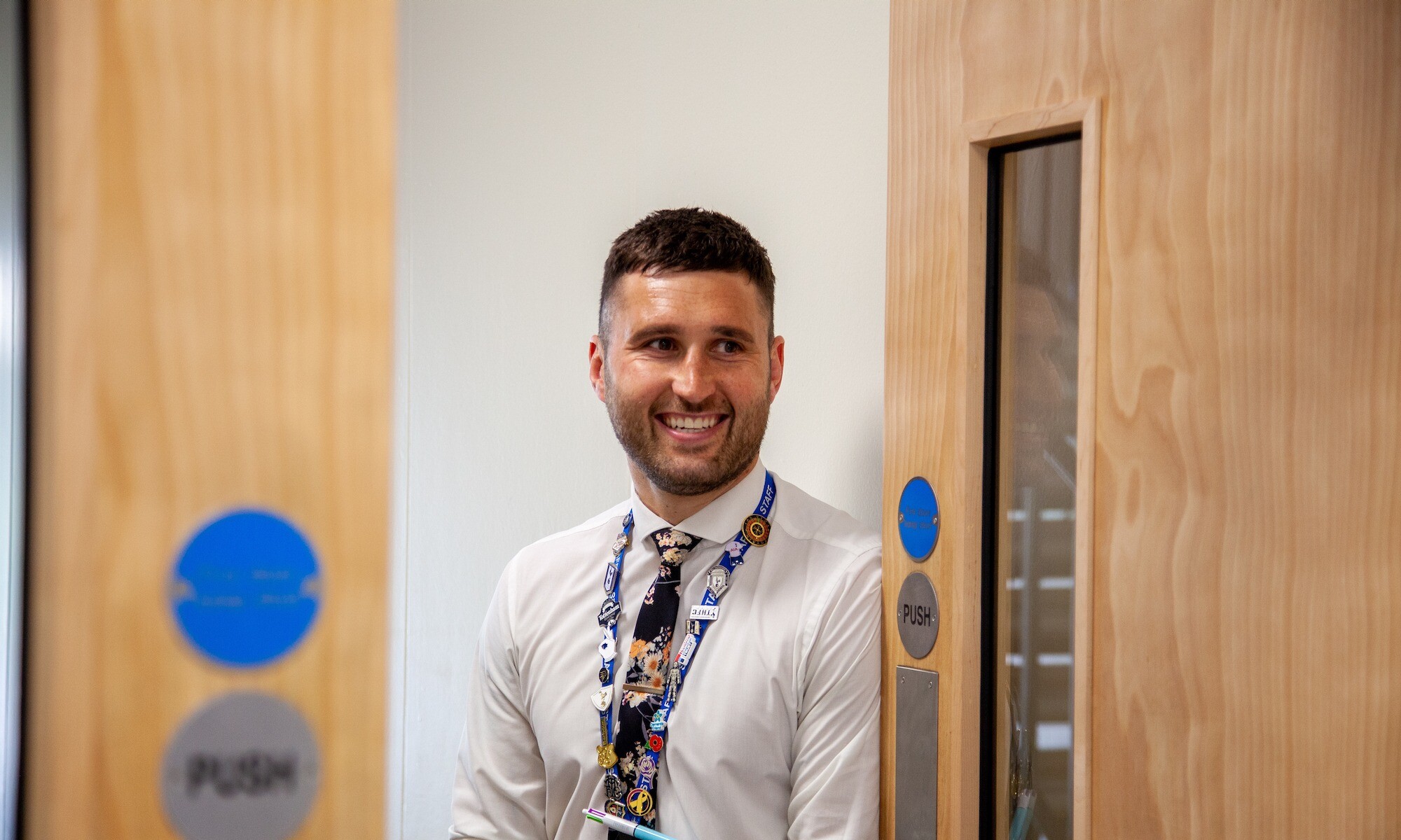Exchange Teacher Training Image of trainee teacher smiling on the way into a classroom